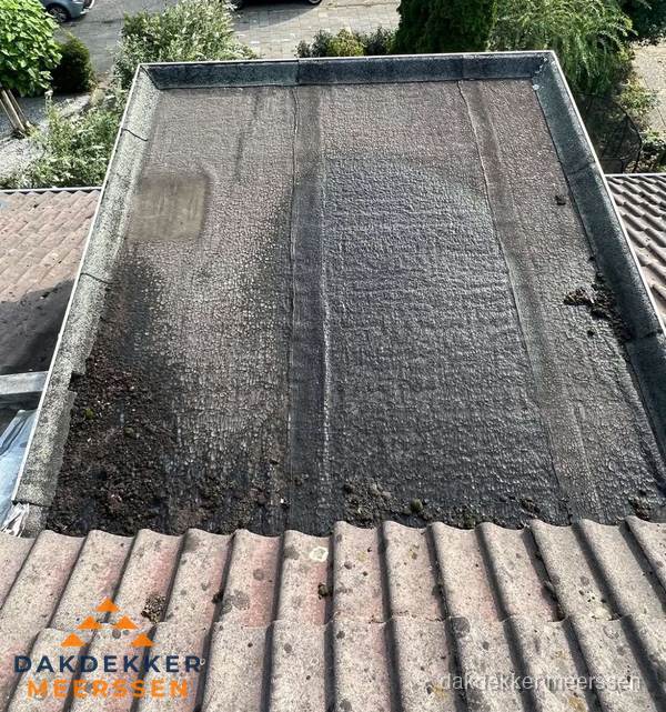 Verouderd plat dak met bitumen en slijtage voor lekkage inspectie in Meerssen Verouderd plat dak met bitumen en slijtage voor lekkage inspectie in Meerssen